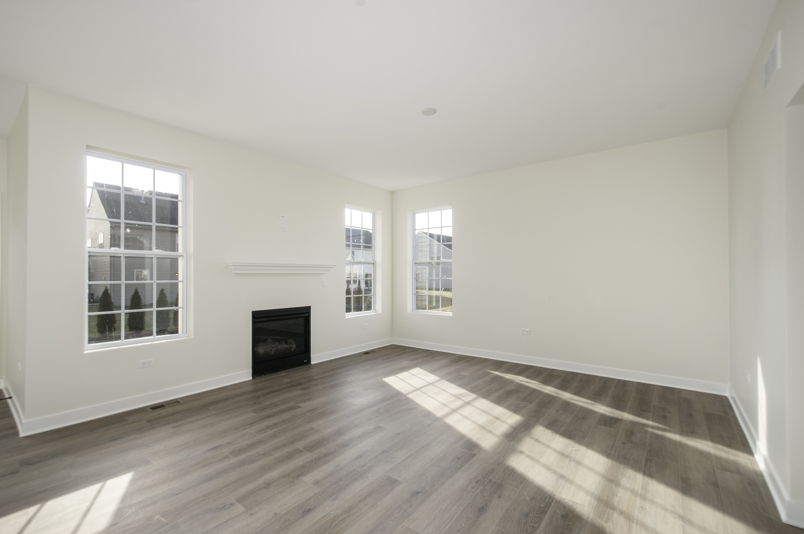1075 Freedom Road Elburn, IL 60119 - Photo 5 of 18 an empty room with windows and fireplace