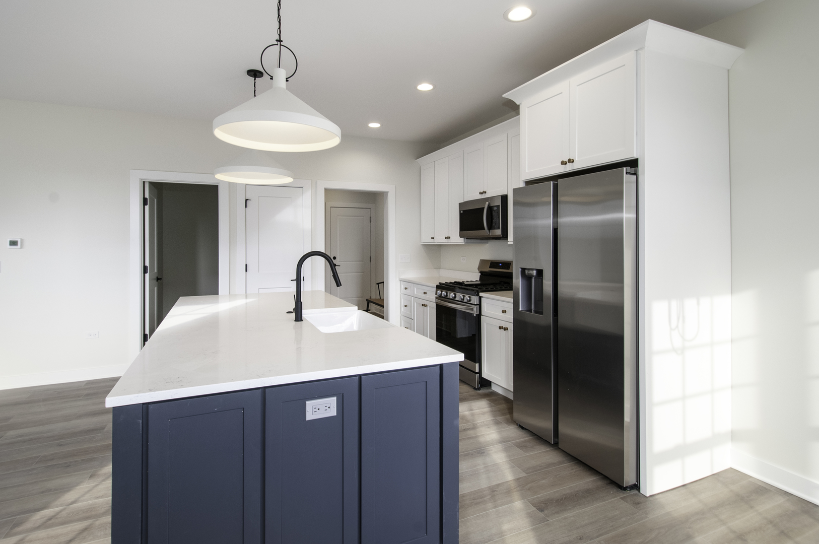 1075 Freedom Road Elburn, IL 60119 - Photo 8 of 18 a kitchen with stainless steel appliances granite countertop a refrigerator a sink and a stove