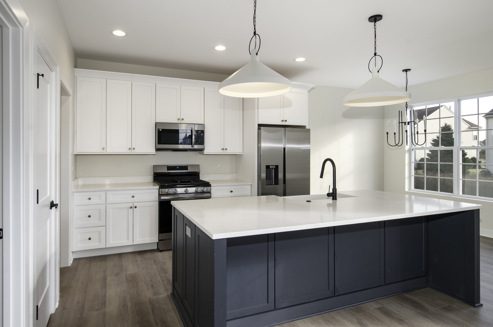1075 Freedom Road Elburn, IL 60119 - Photo 9 of 18 a kitchen with kitchen island a sink stainless steel appliances and cabinets