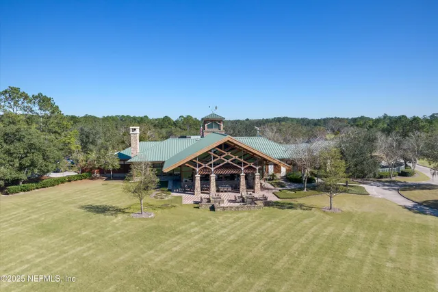an aerial view of residential house with outdoor space and lake view