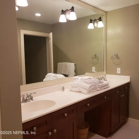 a bathroom with a double vanity sink and a mirror