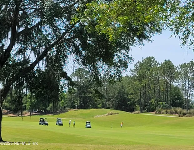 a view of a livingroom with furniture wooden floor and a window