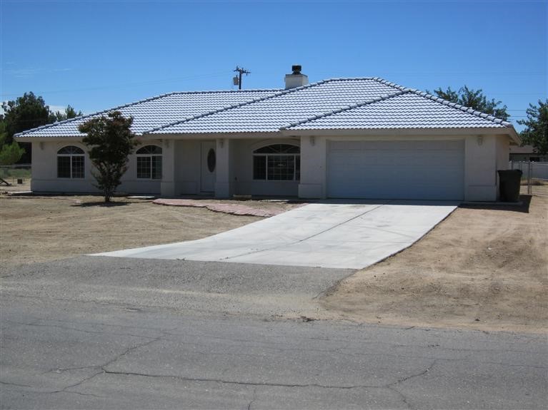 21085 Geronimo Road Apple Valley, CA 92308 - Photo 1 of 1 a front view of a house with a garage