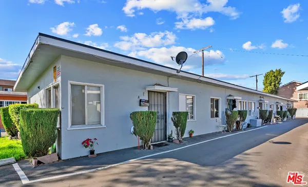 a view of a house with potted plants
