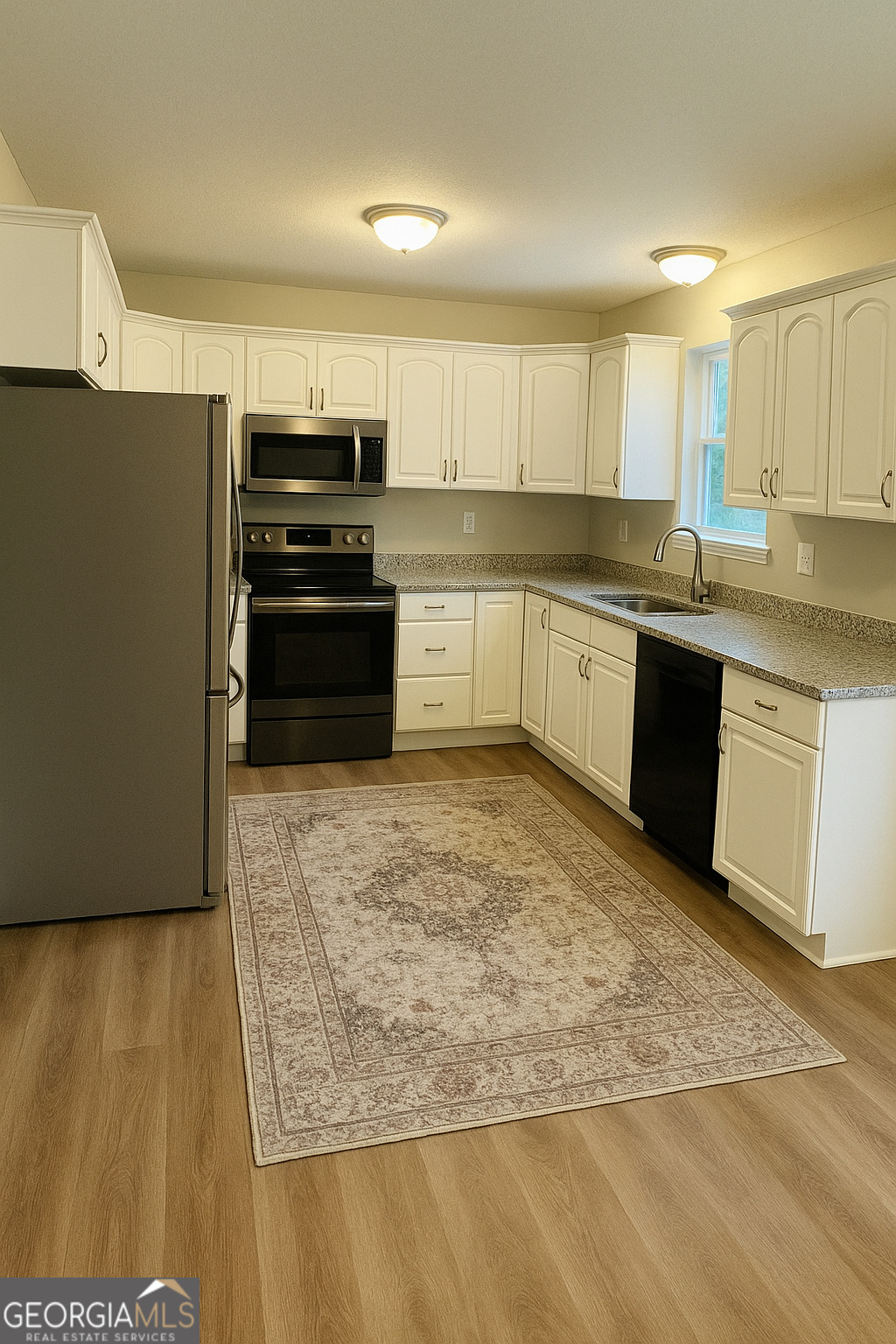 1516 Stark Road Jackson, GA 30233 - Photo 11 of 37 a large kitchen with granite countertop a stove a sink and a microwave
