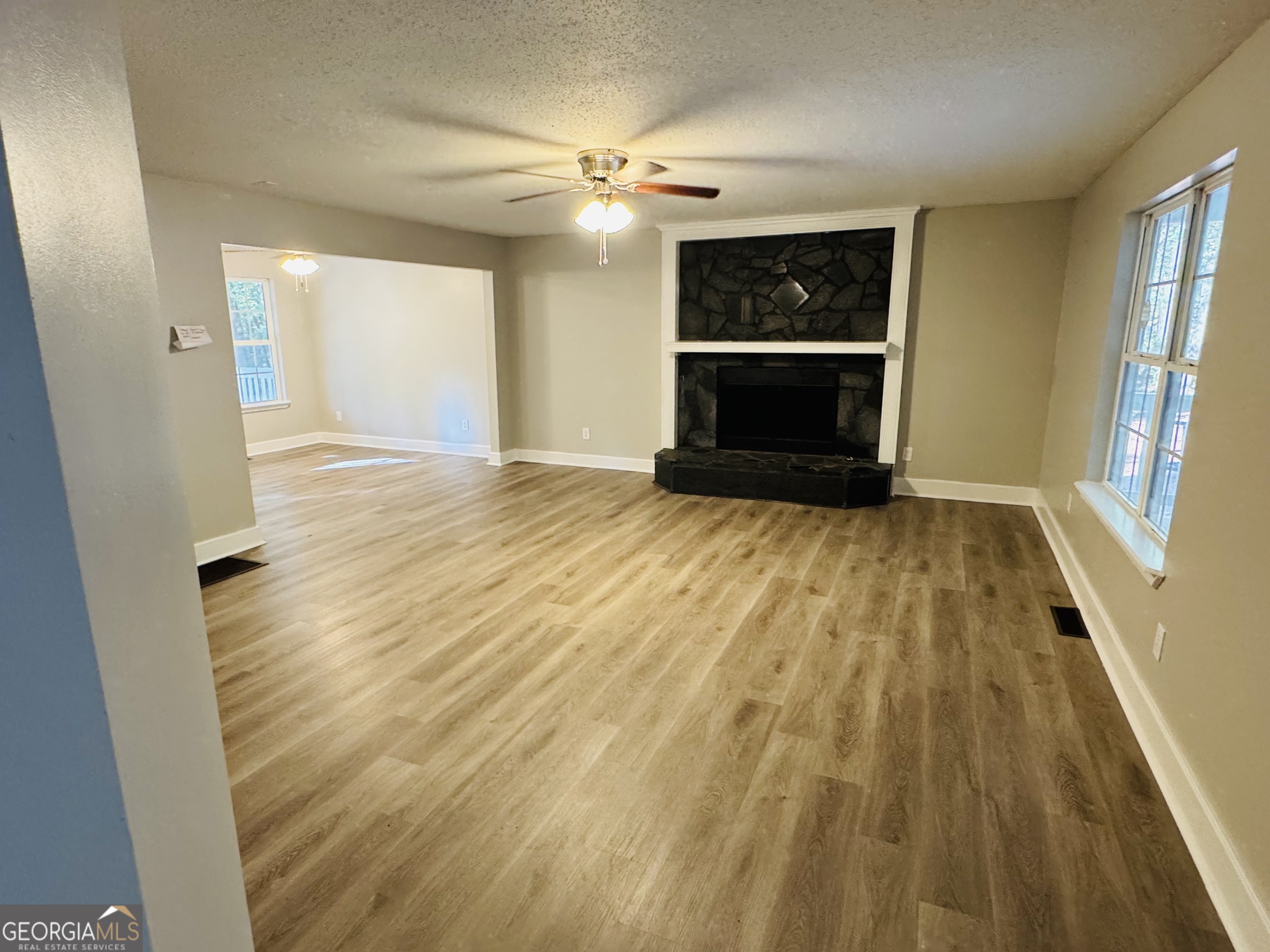 1516 Stark Road Jackson, GA 30233 - Photo 17 of 37 wooden floor in an empty room with a fireplace