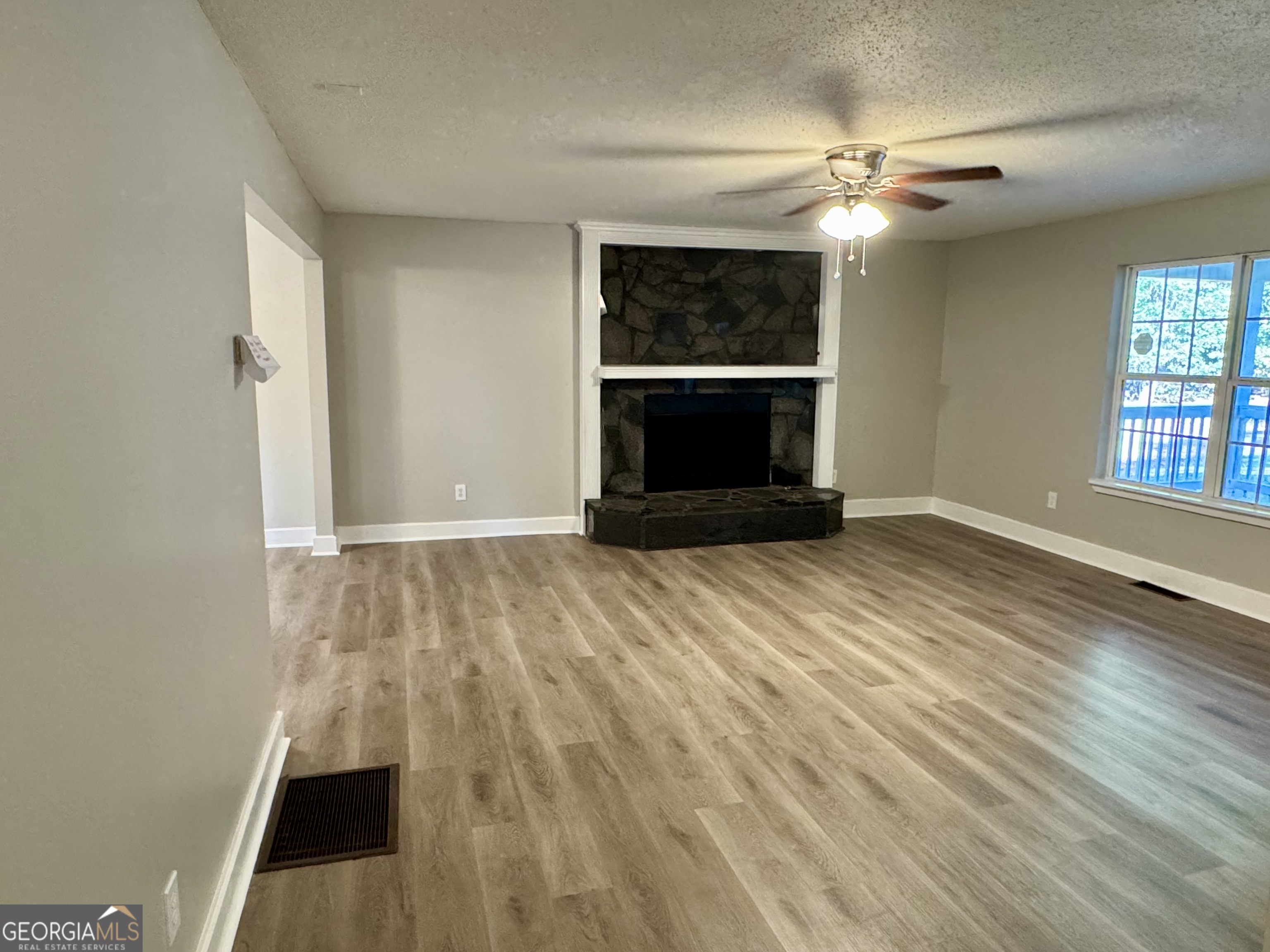 1516 Stark Road Jackson, GA 30233 - Photo 20 of 37 an empty room with wooden floor a ceiling fan and windows