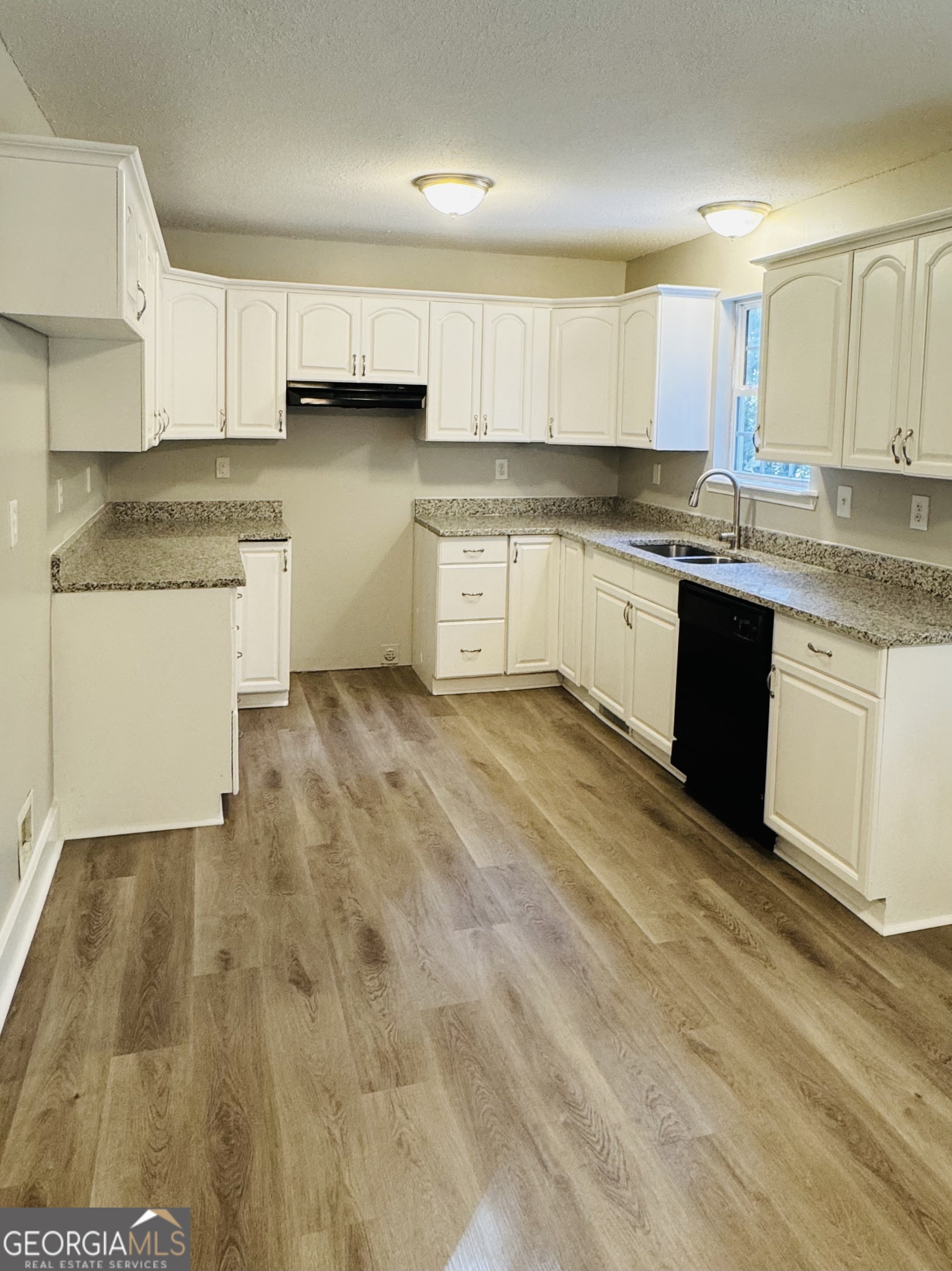 1516 Stark Road Jackson, GA 30233 - Photo 21 of 37 a kitchen with granite countertop white cabinets and white appliances