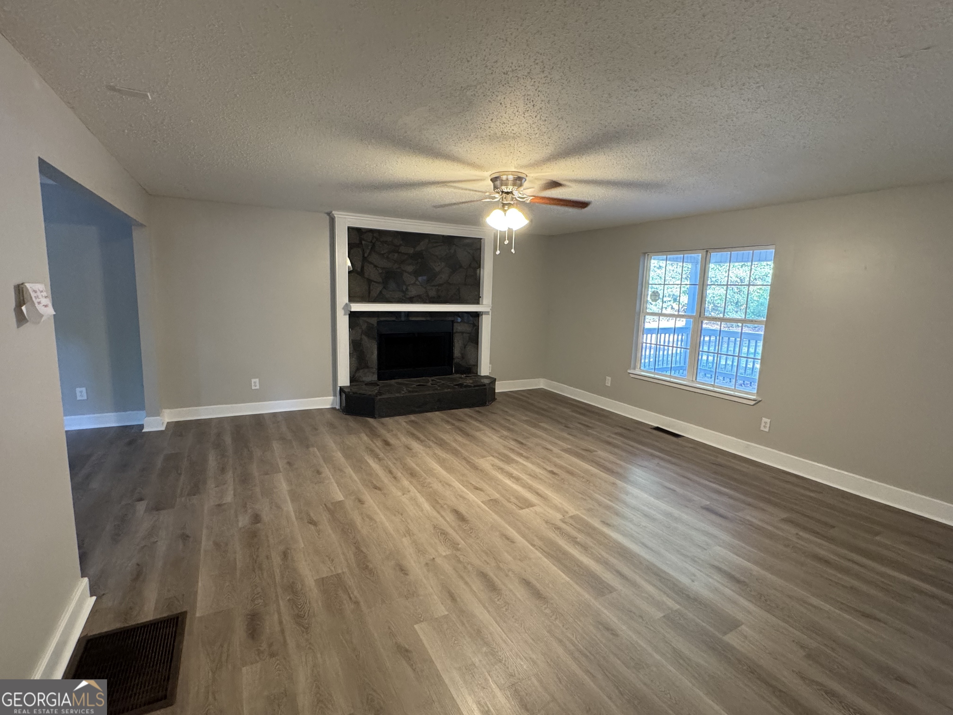 1516 Stark Road Jackson, GA 30233 - Photo 27 of 37 an empty room with windows and fireplace