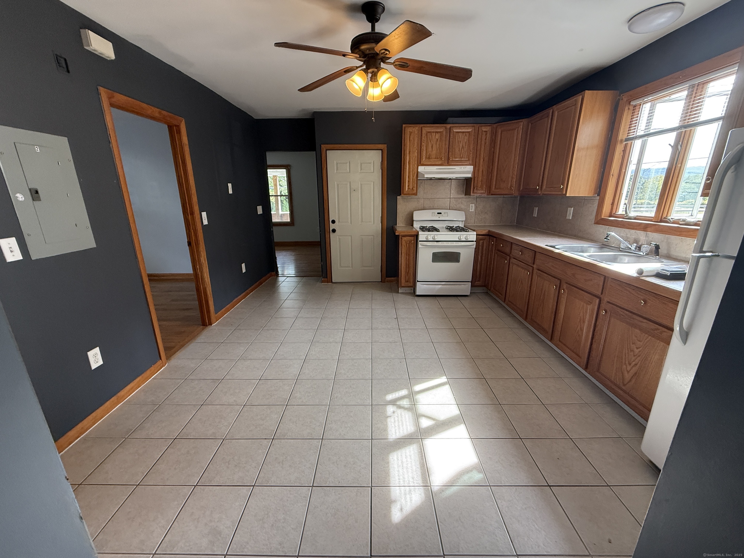 a kitchen with stainless steel appliances granite countertop a refrigerator and a stove top oven