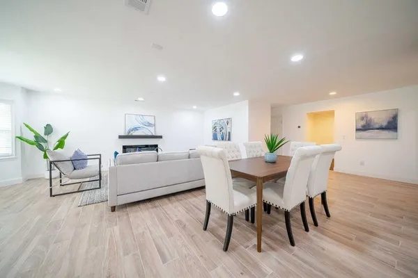 a view of a dining room with furniture and wooden floor