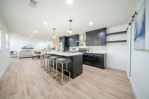 a kitchen with a sink a counter top stainless steel appliances and cabinets