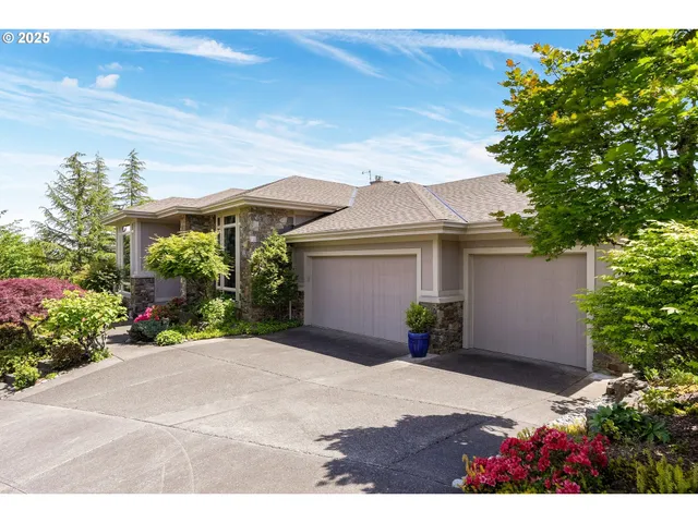 a view of a house with a yard and potted plants