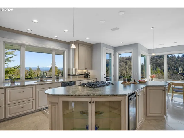 a dining hall with stainless steel appliances granite countertop a sink and dishwasher with wooden floor