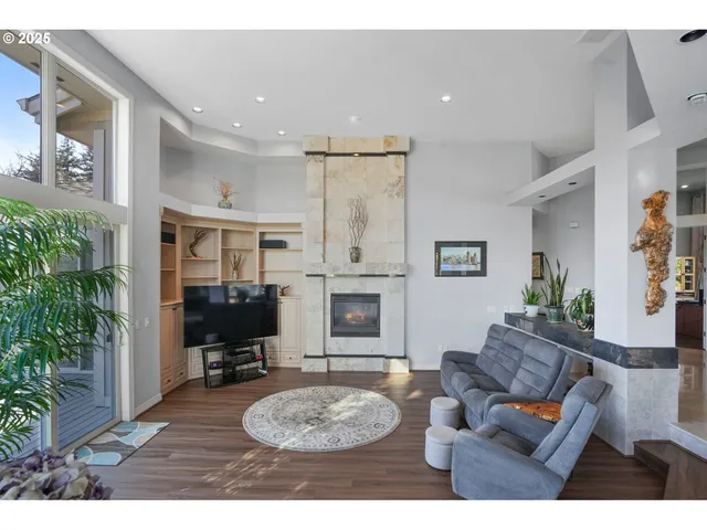 a living room with furniture potted plant and a fireplace