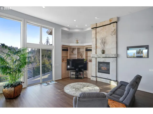 a living room with furniture a fireplace and a potted plant