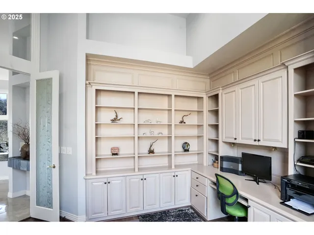 a kitchen with white cabinets and appliances