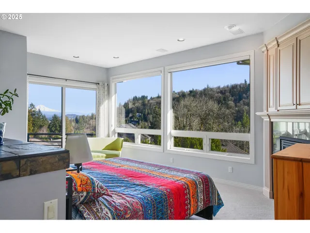 a bedroom with a bed and large window
