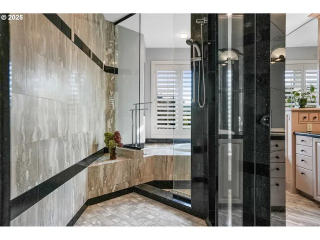 a bathroom with a granite countertop sink and a bathtub