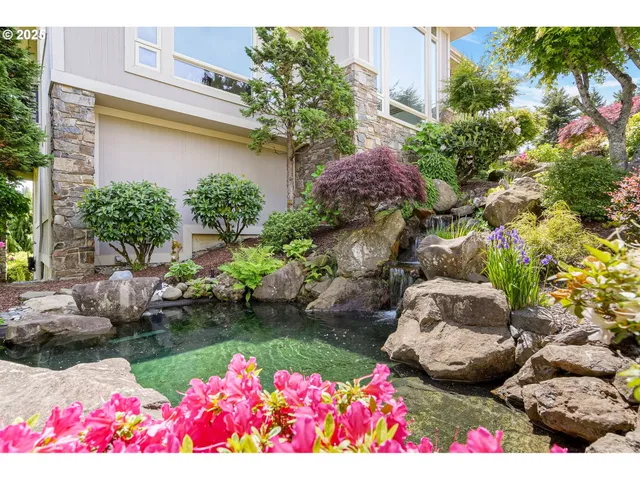 a view of a house with a yard and garden