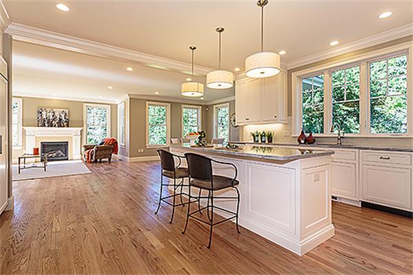 a large kitchen with sink cabinets and wooden floor