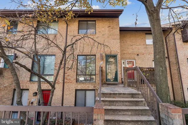 a view of a house with large windows and a small yard