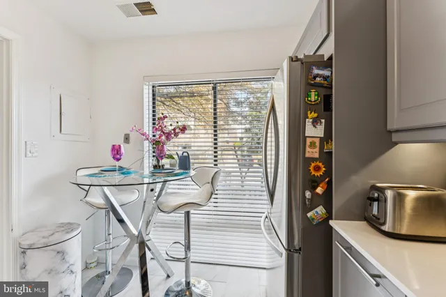 a kitchen with a table and chairs in it