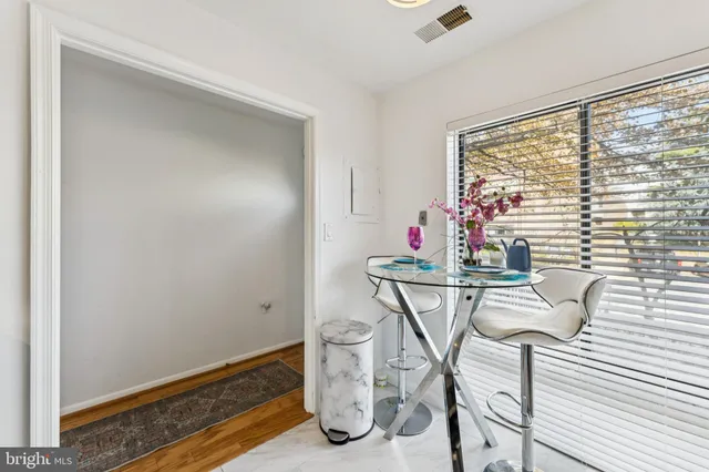 a dining room with furniture and window