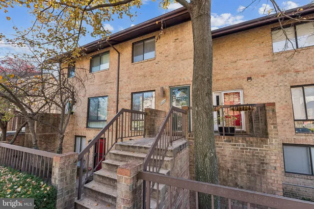 a view of a brick house with many windows