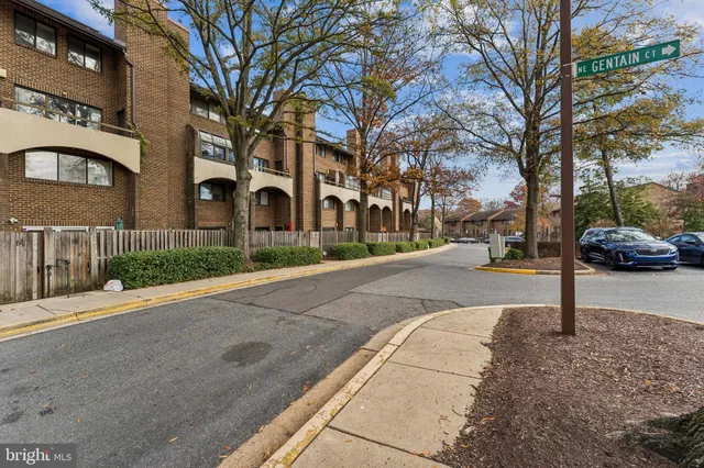 a front view of a building with trees
