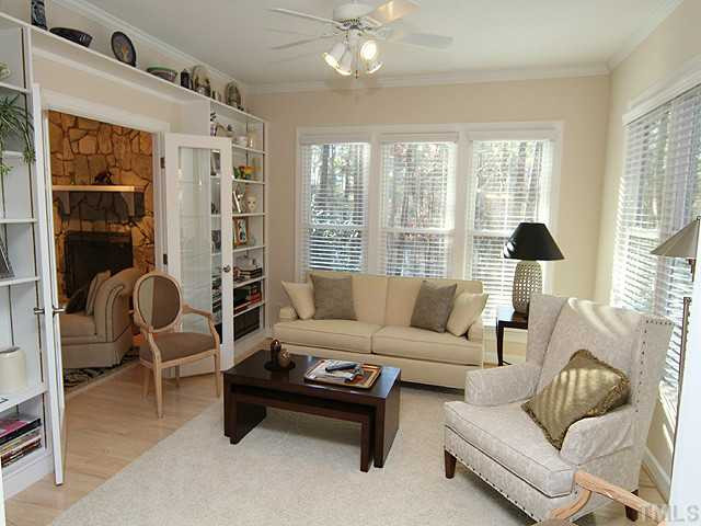 The family room off the kitchen is light filled. A view of the pond can be seen from the side windows as well as from the front yard. Den/Family/Great Room