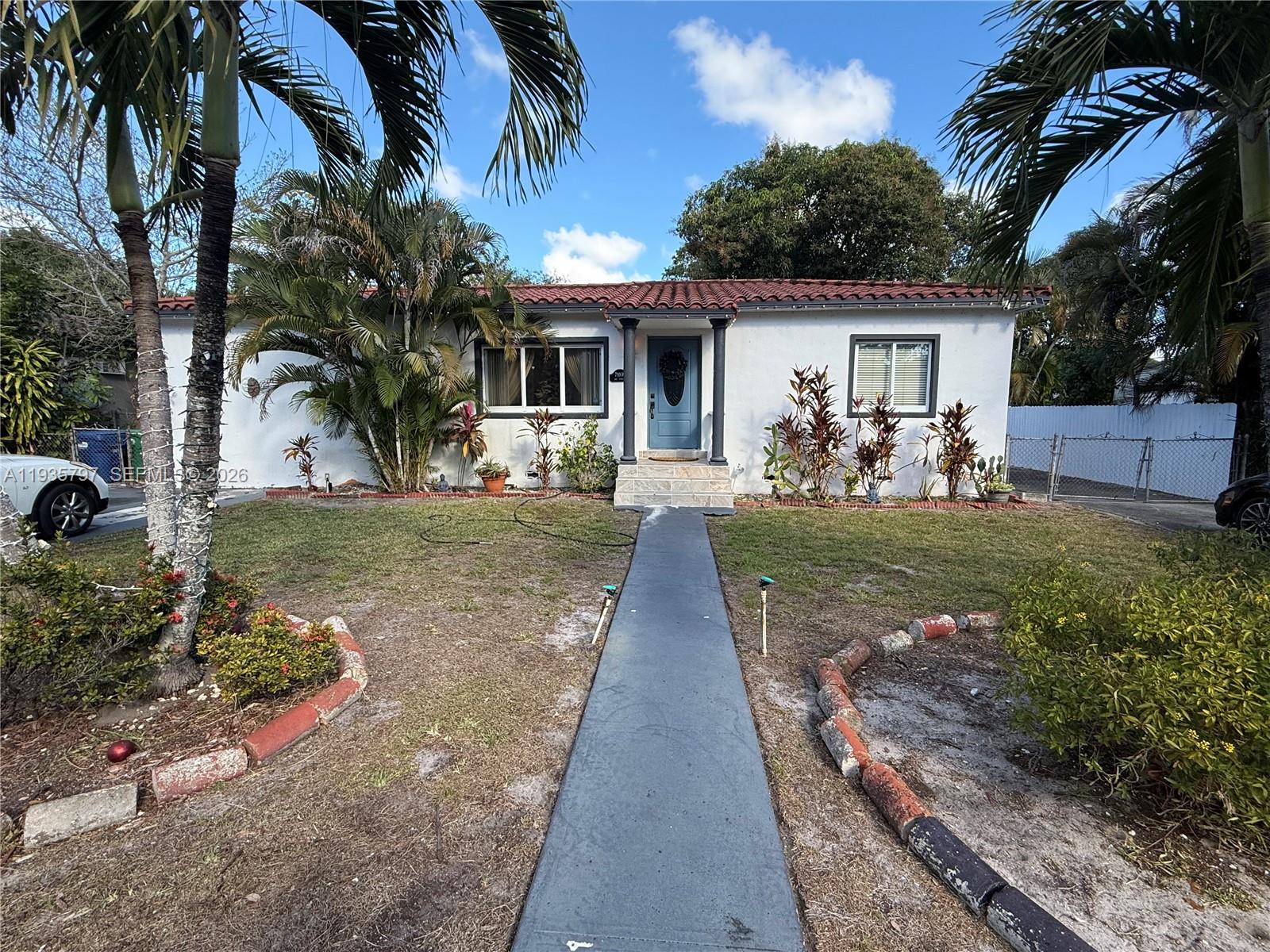 79 Northwest 143rd Street Miami, FL 33168 - Photo 1 of 37 a front view of a house with a yard