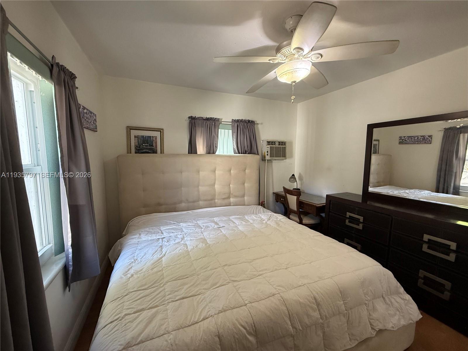 79 Northwest 143rd Street Miami, FL 33168 - Photo 12 of 37 a bedroom with a bed and a large mirror