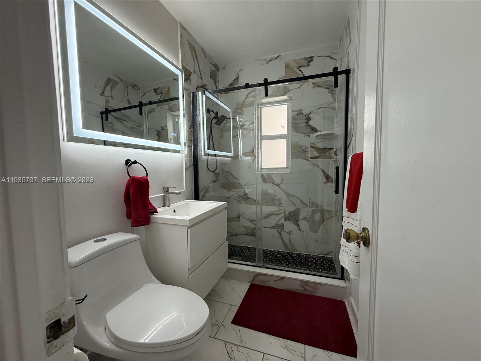 79 Northwest 143rd Street Miami, FL 33168 - Photo 13 of 37 a bathroom with a toilet and shower