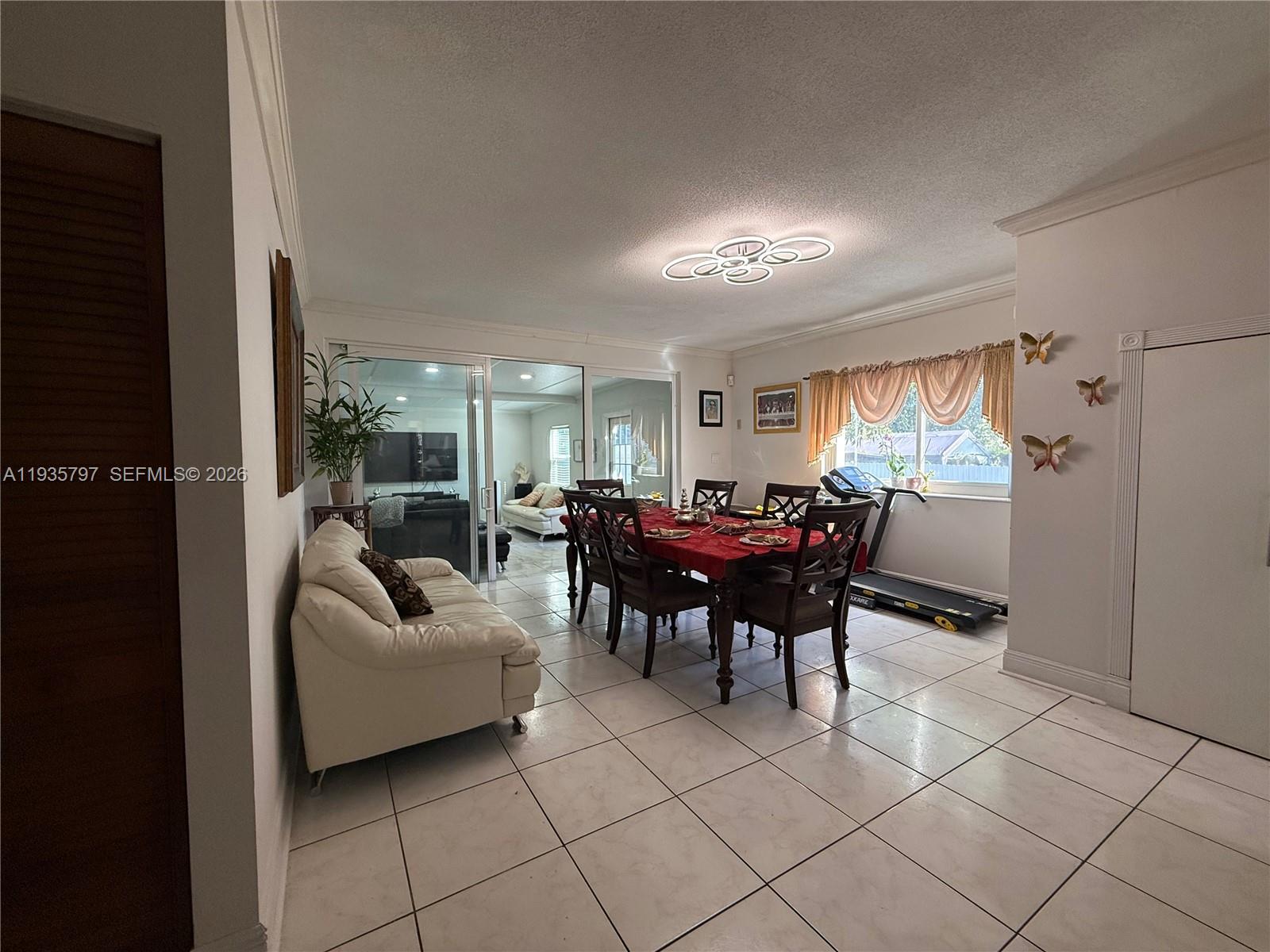 79 Northwest 143rd Street Miami, FL 33168 - Photo 17 of 37 a living room with furniture and a large window