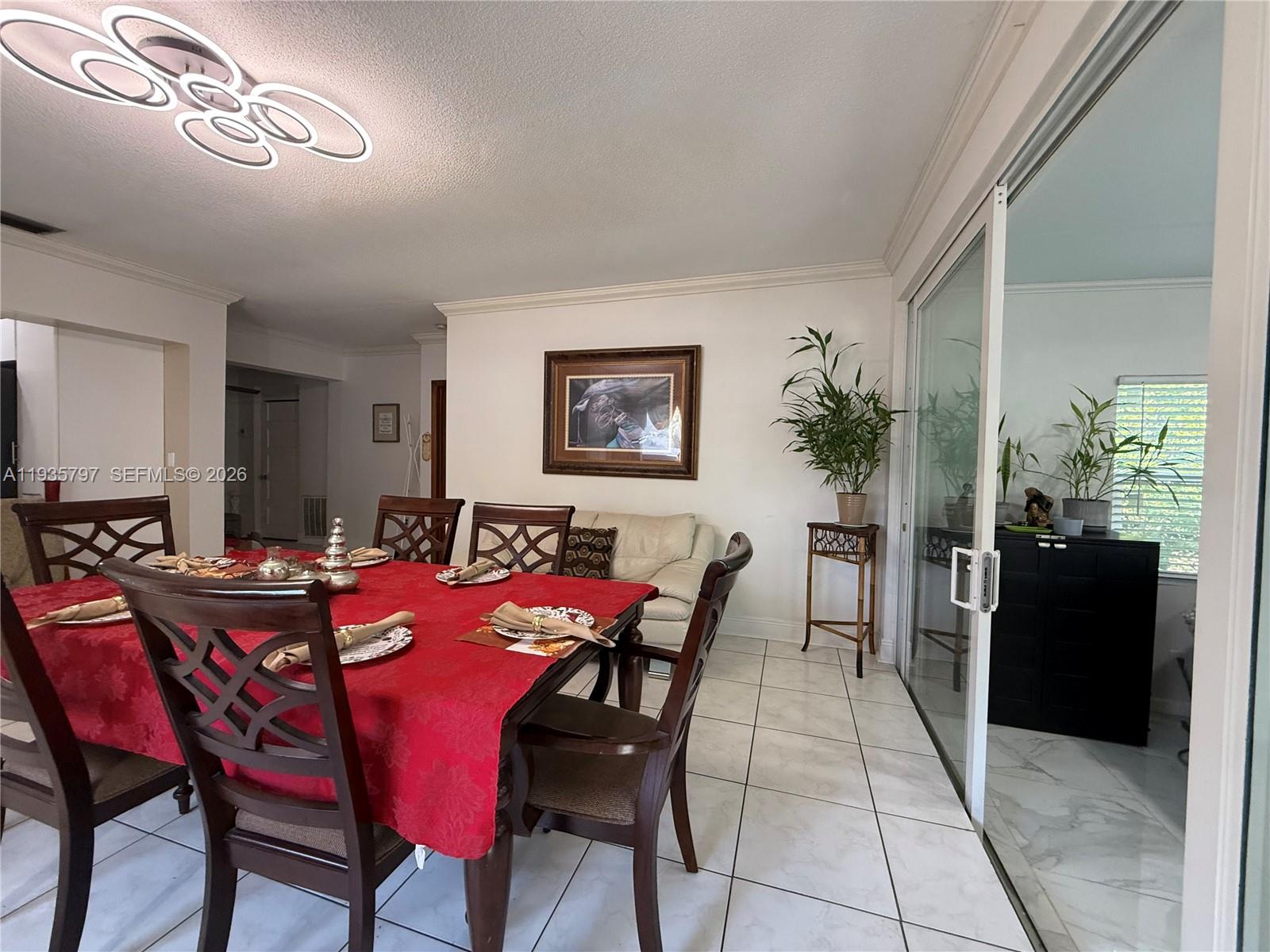 79 Northwest 143rd Street Miami, FL 33168 - Photo 18 of 37 a view of a dining room with furniture