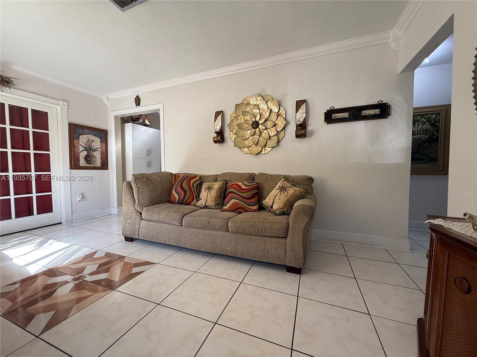 79 Northwest 143rd Street Miami, FL 33168 - Photo 2 of 37 a living room with a couch and a table in it