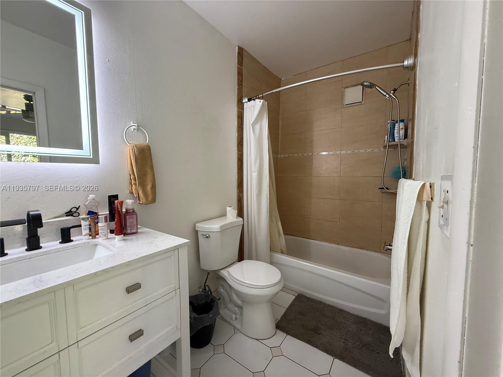 79 Northwest 143rd Street Miami, FL 33168 - Photo 24 of 37 a bathroom with a sink toilet and shower