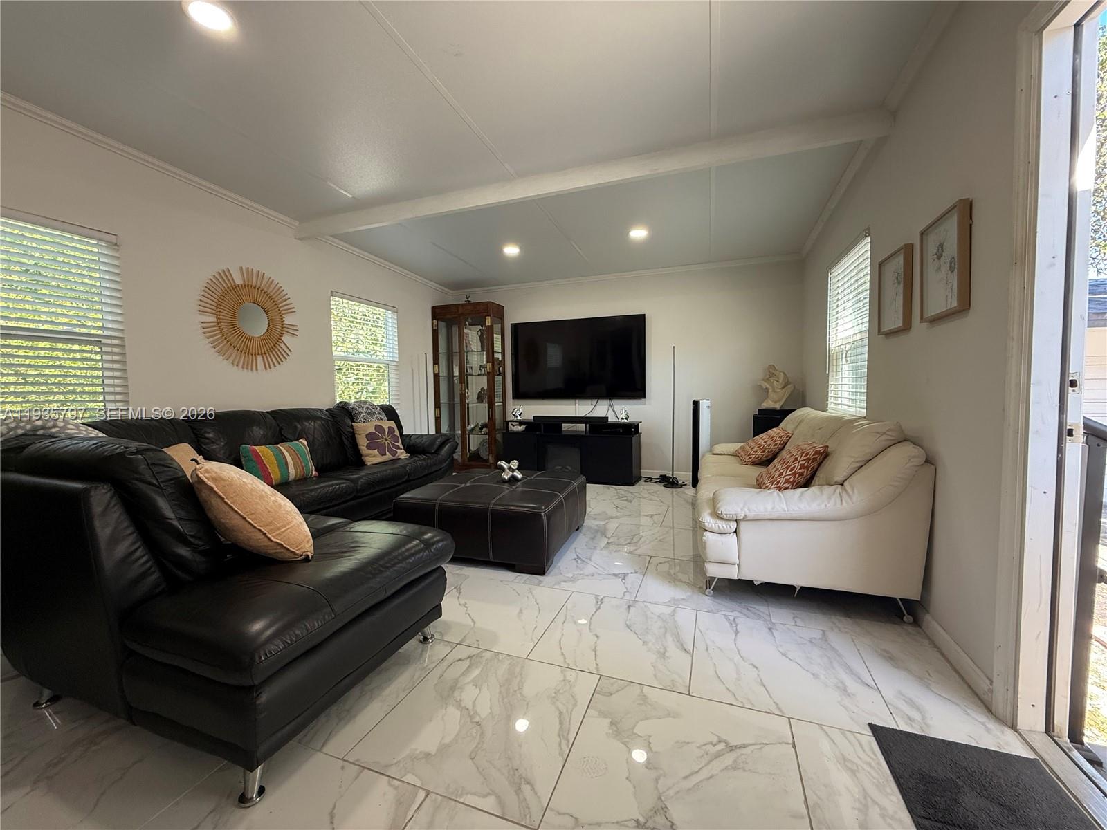 79 Northwest 143rd Street Miami, FL 33168 - Photo 28 of 37 a living room with furniture and a flat screen tv