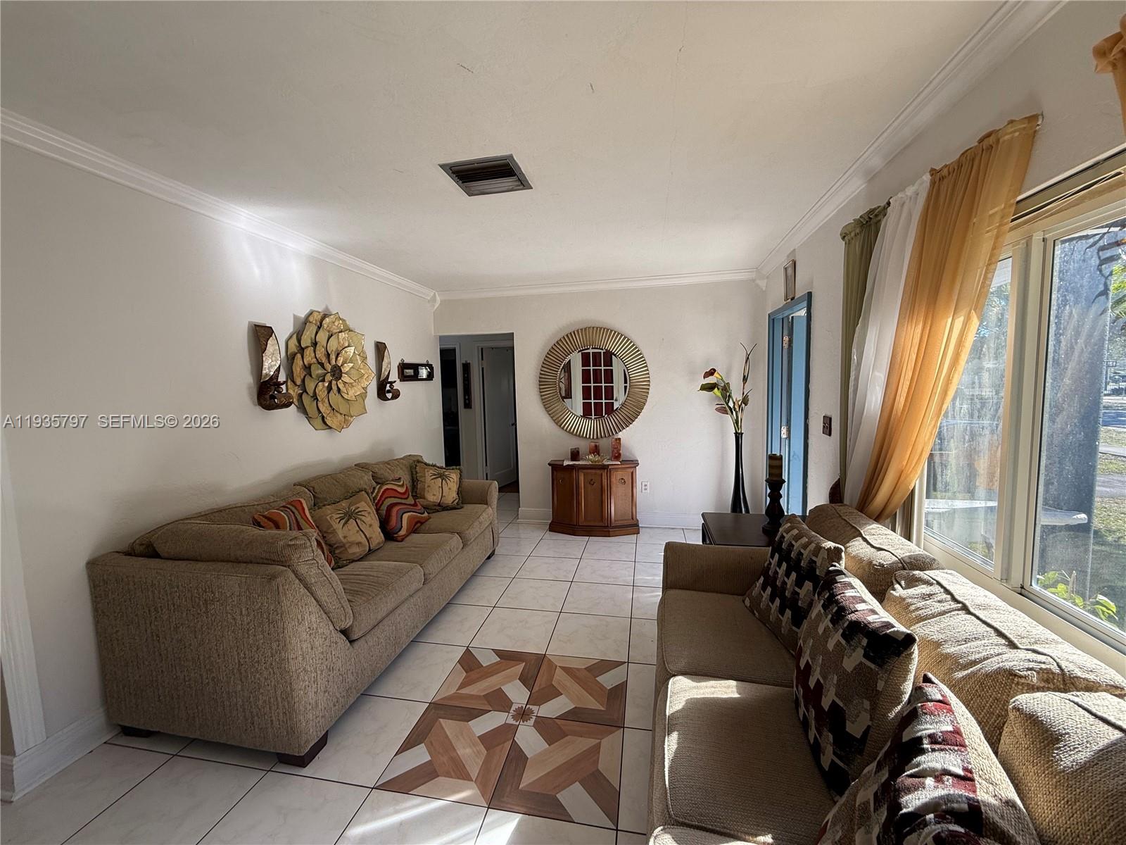 79 Northwest 143rd Street Miami, FL 33168 - Photo 3 of 37 a living room with furniture and a large window