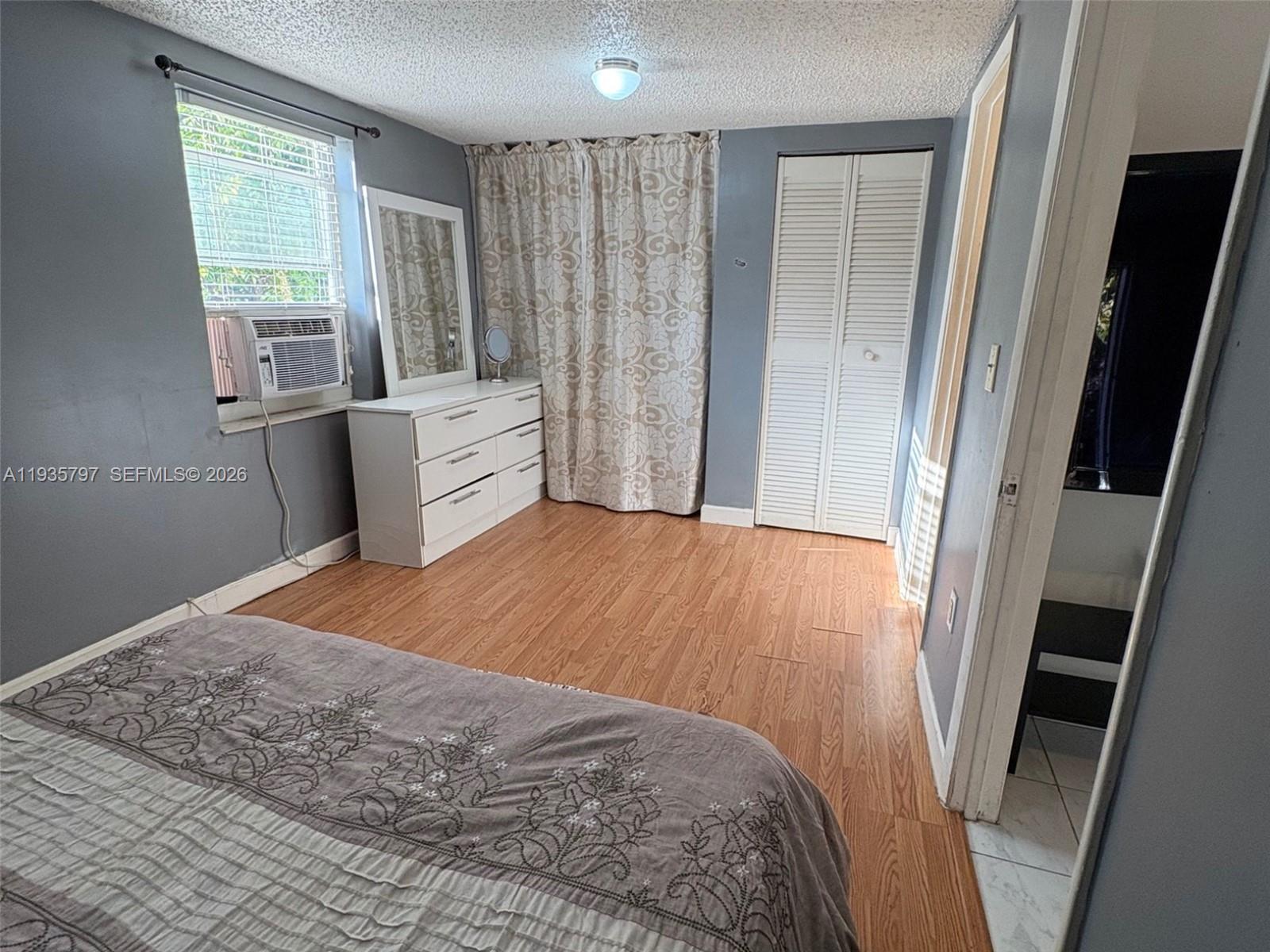 79 Northwest 143rd Street Miami, FL 33168 - Photo 34 of 37 a bedroom with a bed and a window