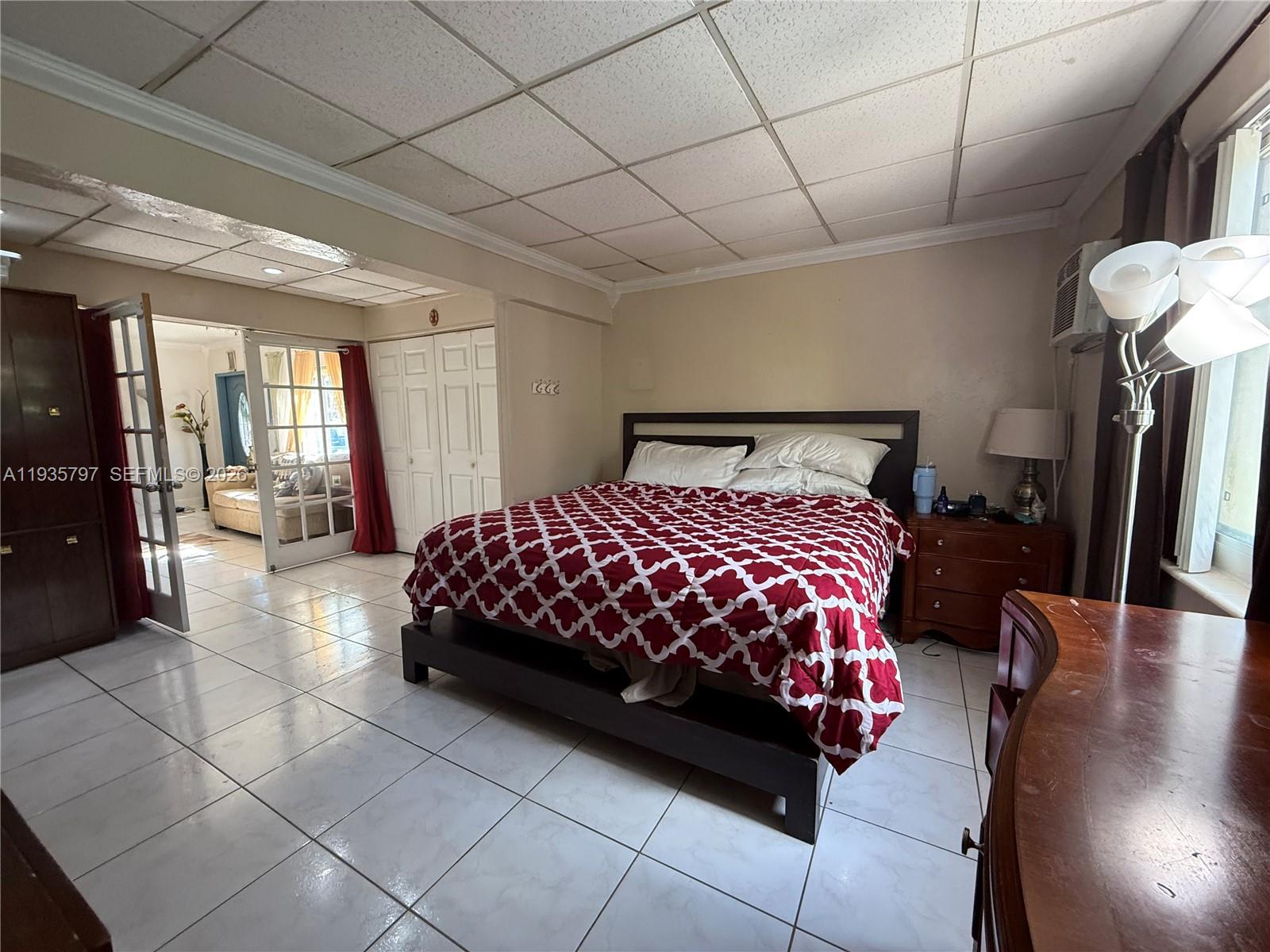 79 Northwest 143rd Street Miami, FL 33168 - Photo 7 of 37 a bedroom with a bed and wooden floor