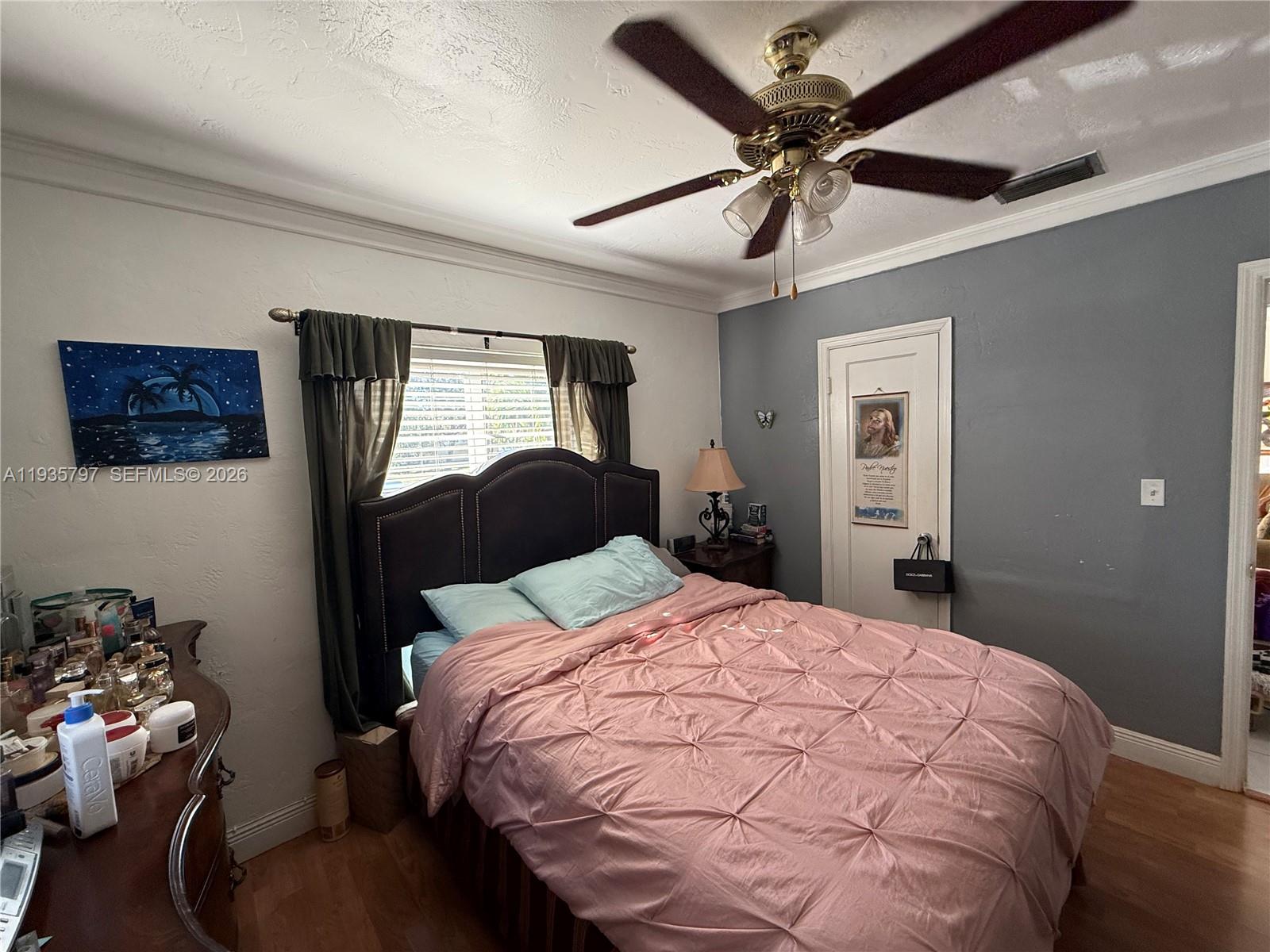 79 Northwest 143rd Street Miami, FL 33168 - Photo 10 of 37 a bedroom with a bed and a chandelier