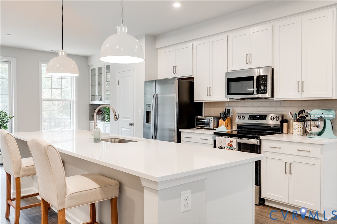 13267 Garland Lane Midlothian, VA 23114 - Photo 11 of 35 a kitchen that has a lot of white cabinets and stainless steel appliances