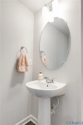 a bathroom with a sink a mirror and vanity