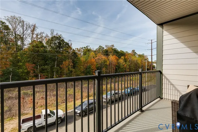 a view of a balcony with wooden fence and floor