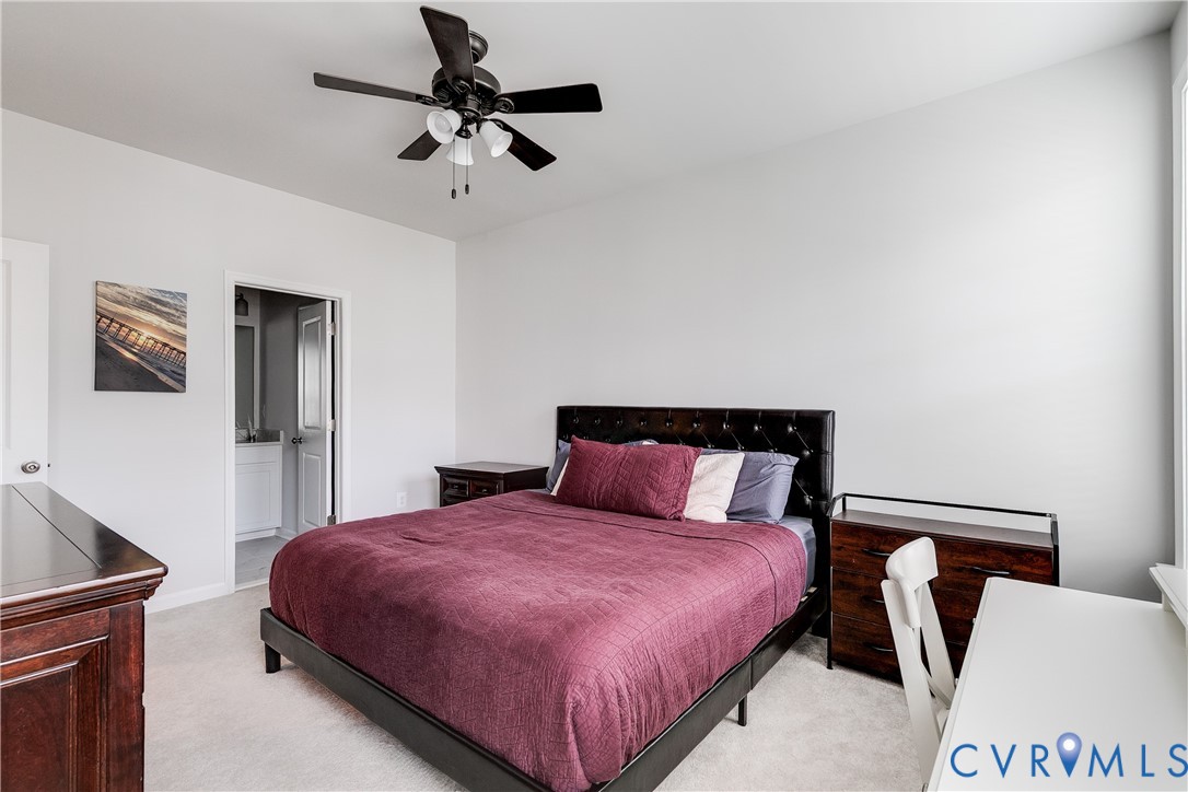 13267 Garland Lane Midlothian, VA 23114 - Photo 19 of 35 a bedroom with a bed and a chandelier