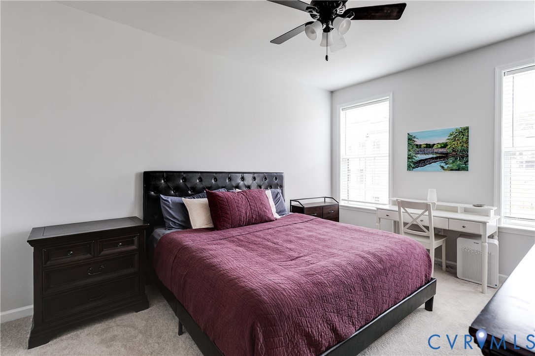 13267 Garland Lane Midlothian, VA 23114 - Photo 20 of 35 a bedroom with a bed and a chandelier