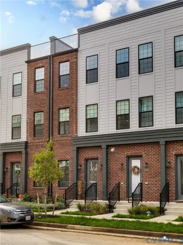 a front view of a residential apartment building with a yard