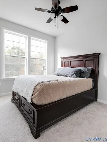 a large bed sitting in a bedroom next to a window